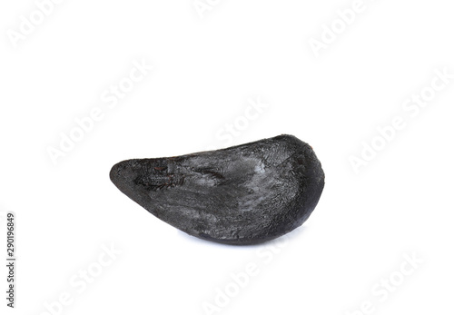 Clove of aged black garlic on white background © New Africa