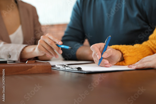 Schilderij op canvas Female notary working with mature couple in office, closeup