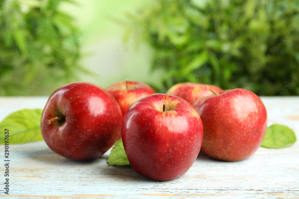 Ripe juicy red apples on white wooden table against blurred background. Space for text Ripe juicy red apples on white wooden table against blurred background. Space for text