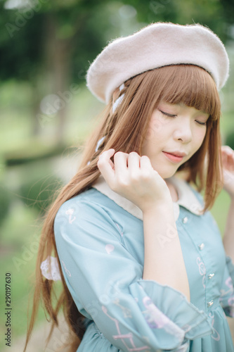 Portrait of asian girl in lolita fashion dress in garden background