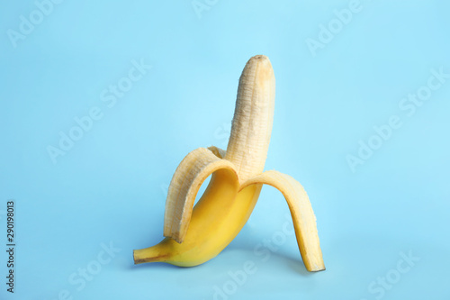 Fresh banana on light blue background. Sex concept photo