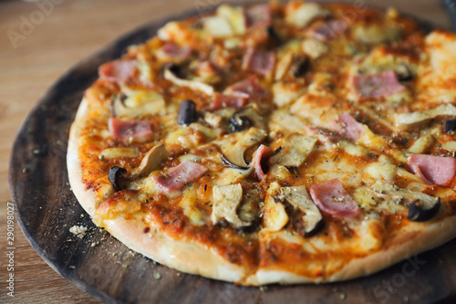 pizza ham and mushroom on wood background