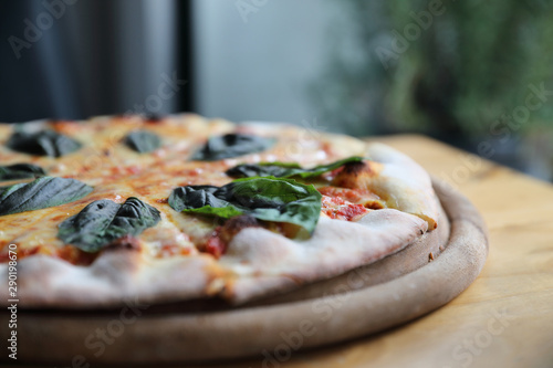 pizza margherita , Italian Pizza with Tomatoes , Basil and Mozzarella Cheese on wood background