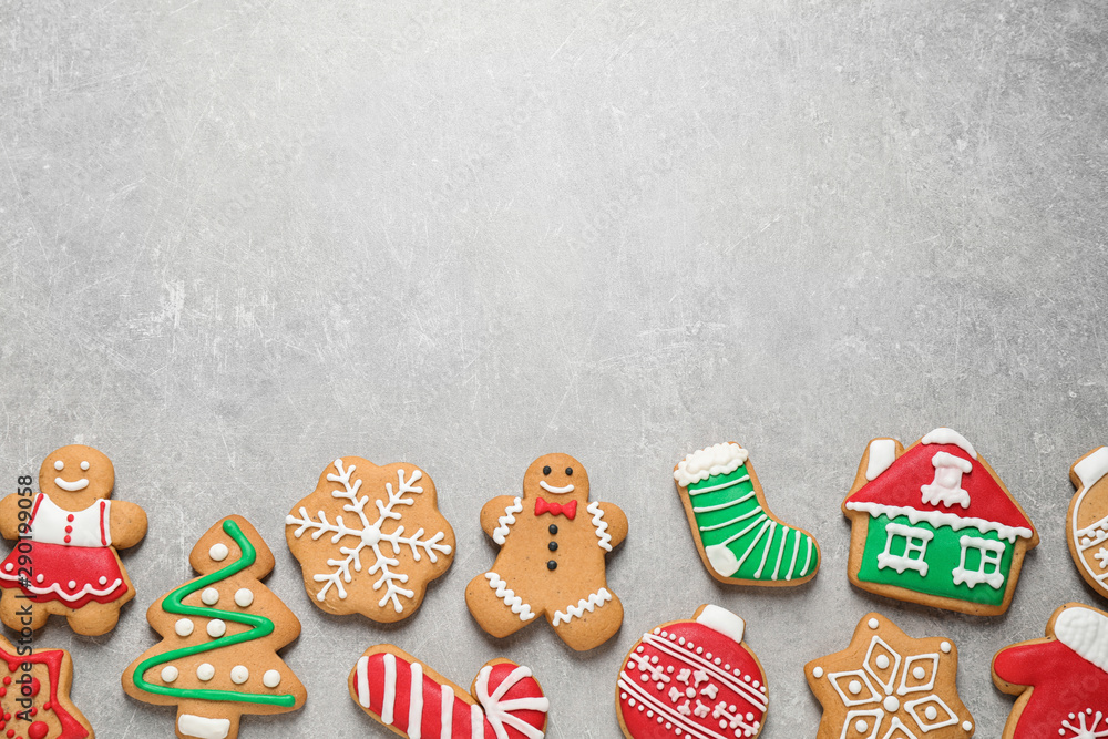 Flat lay composition with tasty homemade Christmas cookies on grey table, space for text