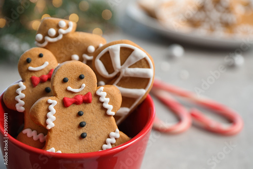 Tasty homemade Christmas cookies in cup on grey table, closeup view