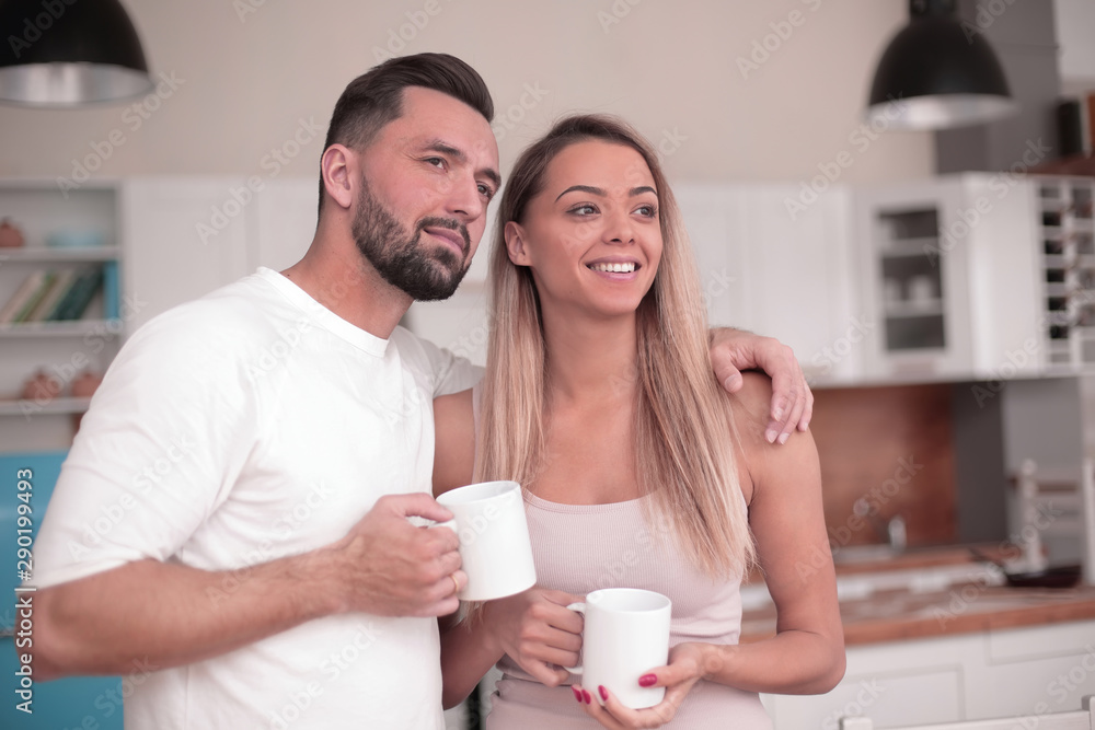 dreams of a young couple standing in their kitchen dreams of a young couple standing in their kitchen