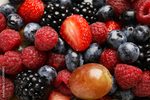 Fresh tasty fruit salad as background, top view