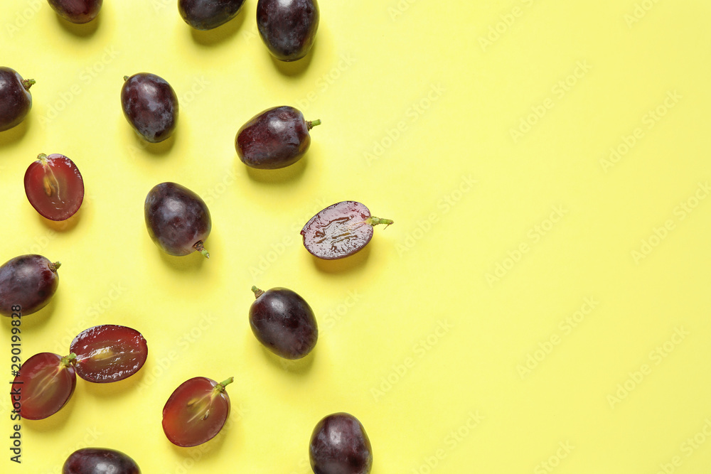 Flat lay composition with fresh ripe juicy grapes on yellow background, space for text Flat lay composition with fresh ripe juicy grapes on yellow background, space for text