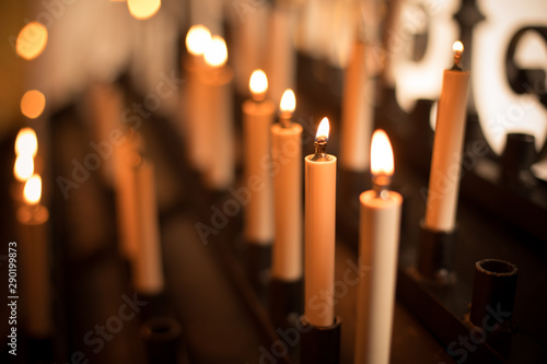 Rows of burning candles photo