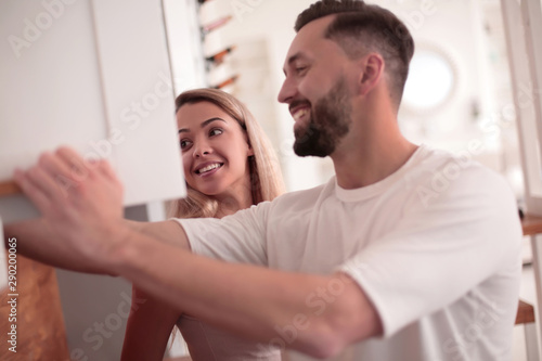 close up. a married couple talking standing in their kitchen.