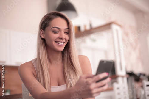 close up. serious young woman reading SMS on her smartphone