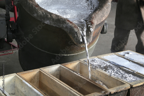 Molten metal is poured into molds at a factory