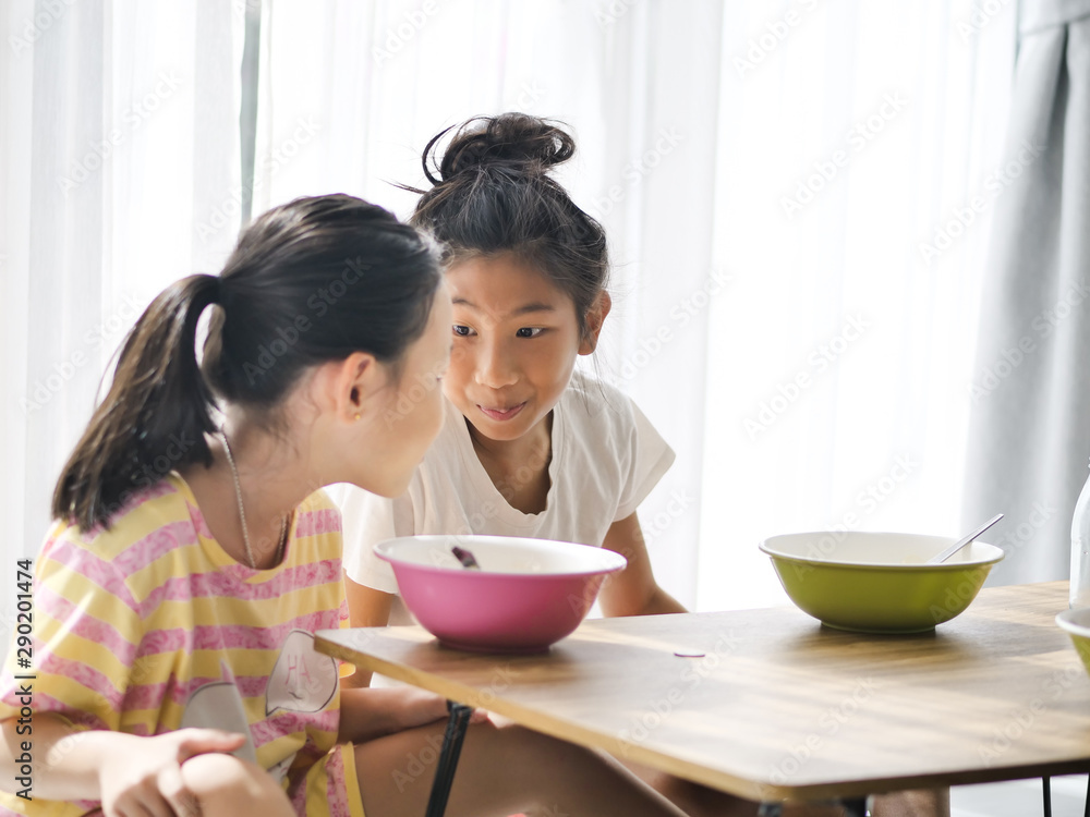 Asian children eating together at home, lifestyle concept. Asian children eating together at home, lifestyle concept.