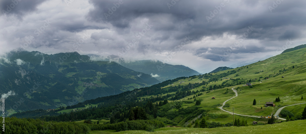 A landscape image of a beautiful mountain scenery with heavy clouds in the Swiss Alps.