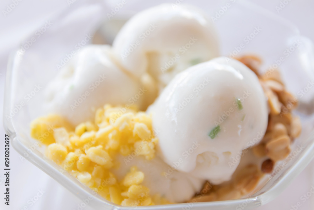 Coconut ice cream with nuts in glass bowl. Coconut ice cream with nuts in glass bowl.