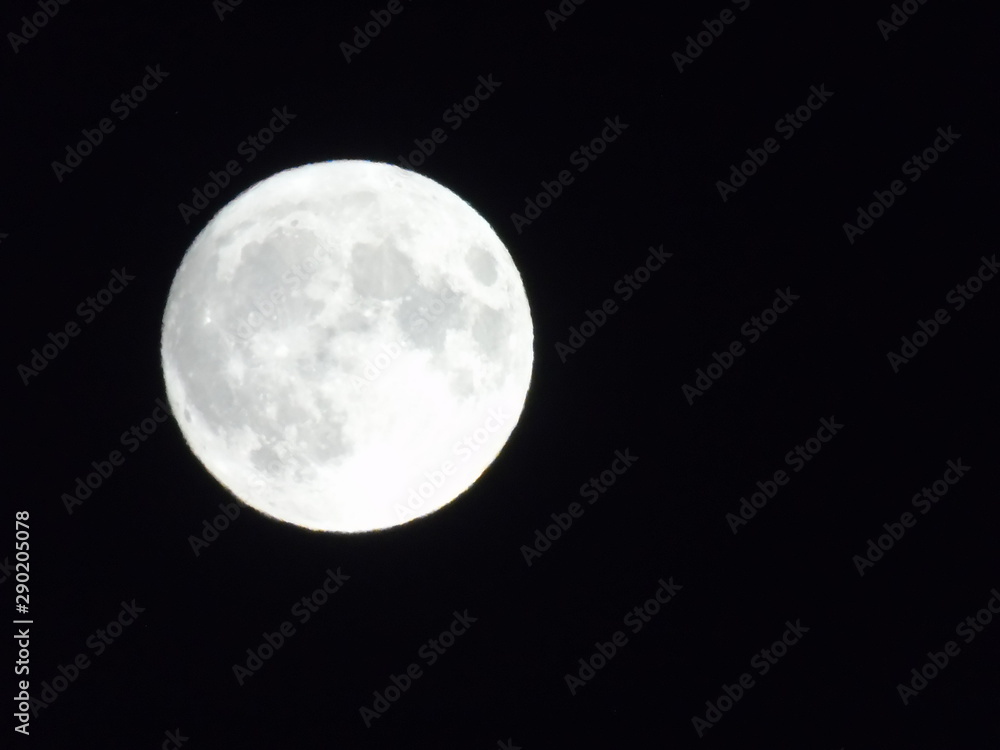 Fototapeta premium An amazing photography of the full moon over the city of Genova by night with a great clear sky in background and some stars