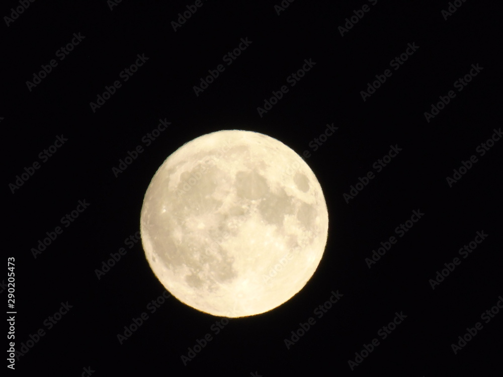 Fototapeta premium An amazing photography of the full moon over the city of Genova by night with a great clear sky in background and some stars