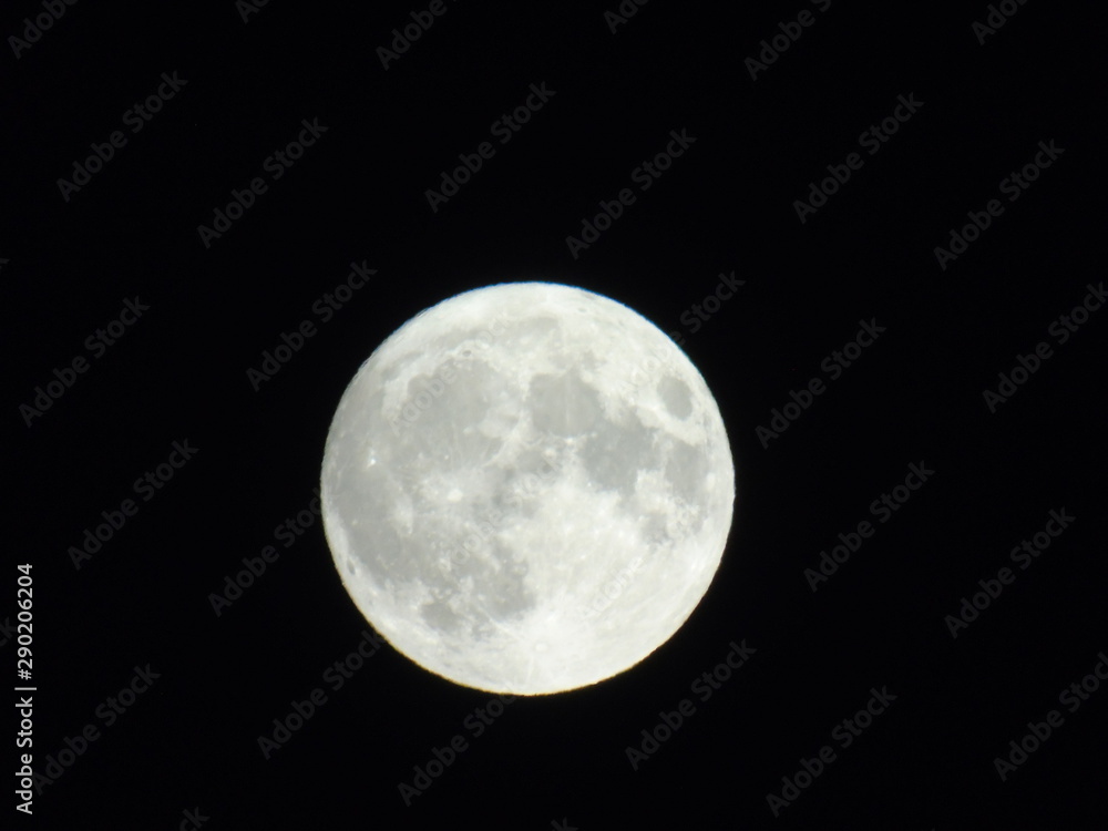 An amazing photography of the full moon over the city of Genova by night with a great clear sky in background and some stars An amazing photography of the full moon over the city of Genova by night with a great clear sky in background and some stars