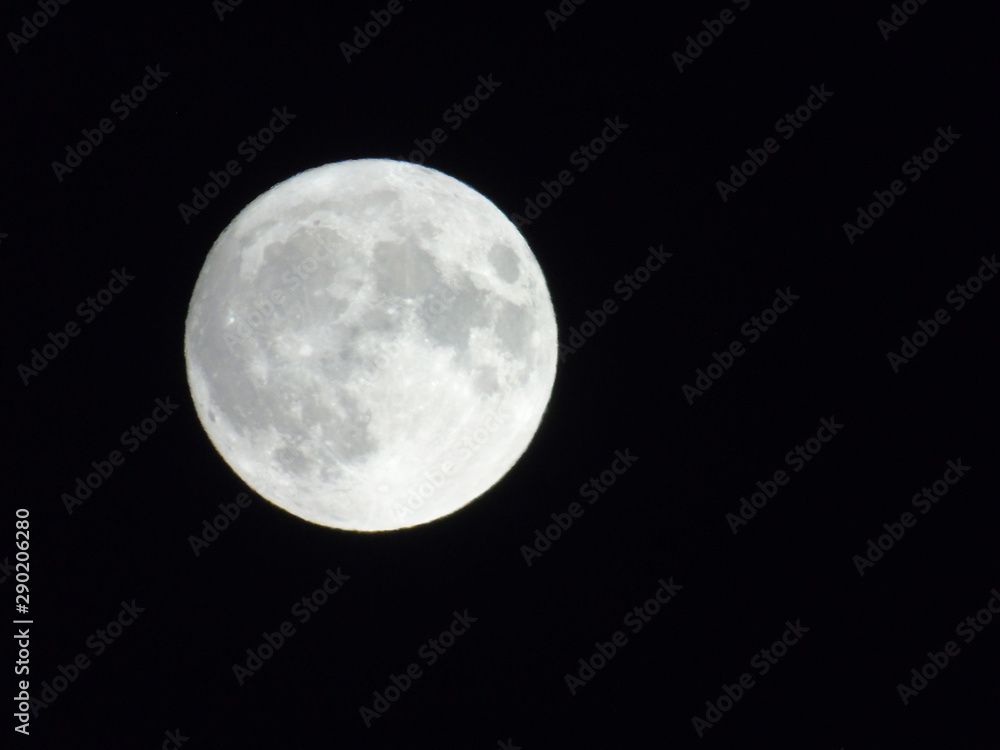An amazing photography of the full moon over the city of Genova by night with a great clear sky in background and some stars An amazing photography of the full moon over the city of Genova by night with a great clear sky in background and some stars