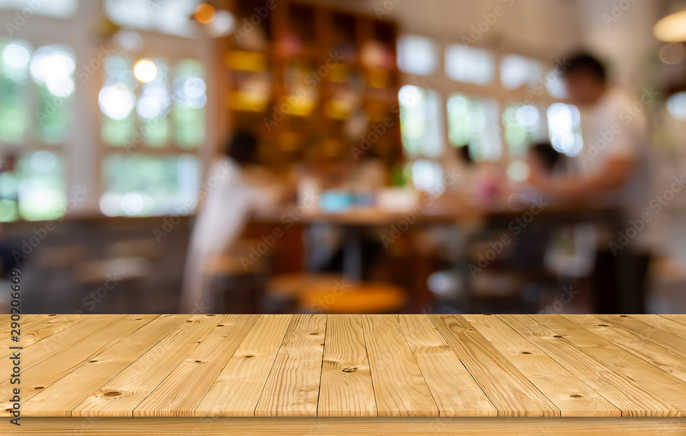 Empty brown old plank wooden board as mock up display shelf with blurred customer in coffee shop or bistro and soft bokeh from electric lamp and window lighting background.