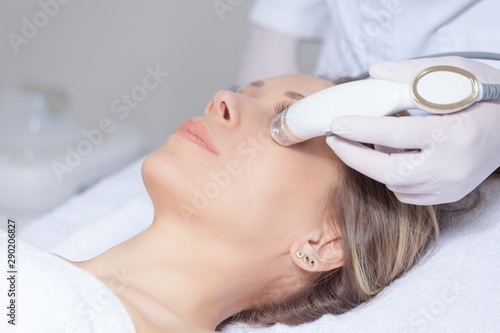 woman face skin treatment in beauty health clinic close