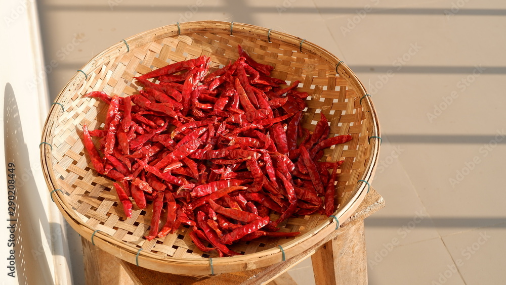 dried chili in a bamboo basket on chair , Thai cooking ingredients dried chili in a bamboo basket on chair , Thai cooking ingredients
