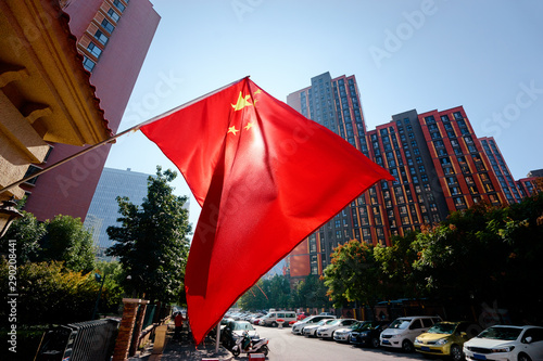 Chinese national flag in front of the modern buildings in Beijing.