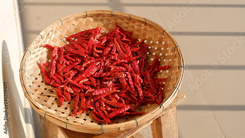 dried chili in a bamboo basket on chair   Thai cooking ingredients