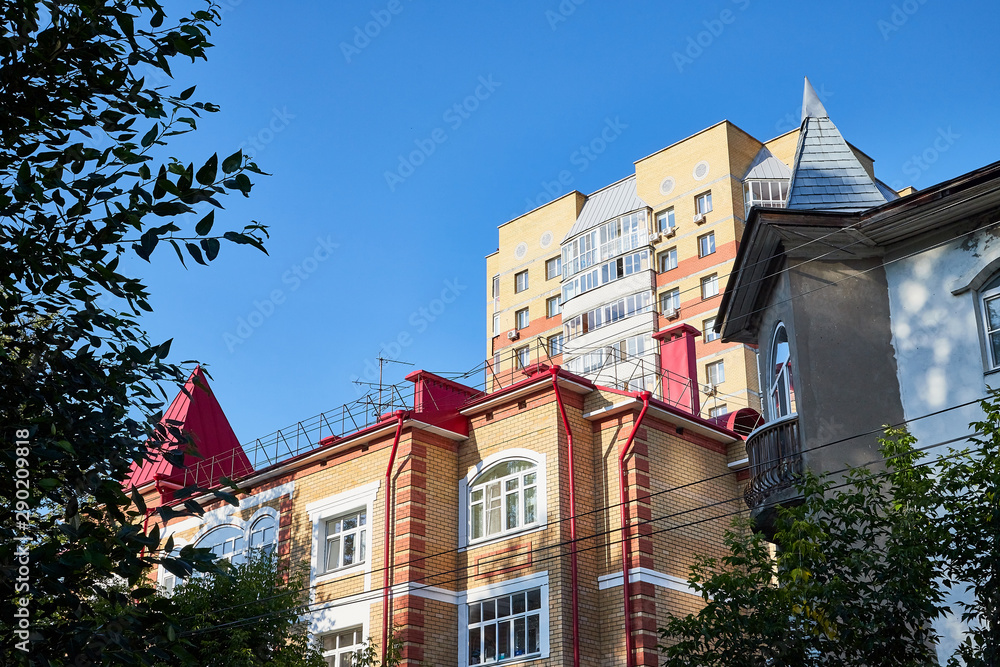 Facade of building with flats and offices and sky background