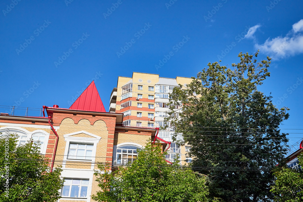Facade of building with flats and offices and sky background Facade of building with flats and offices and sky background
