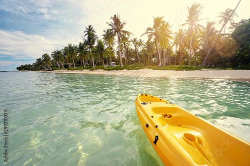 Yellow kayak on the tropical beach.