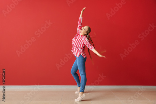 Cool young woman dancing ag...