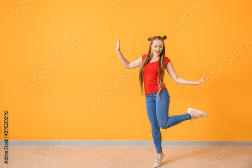 Cool young woman dancing ag...
