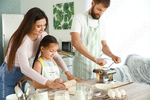 Young family cooking togeth...