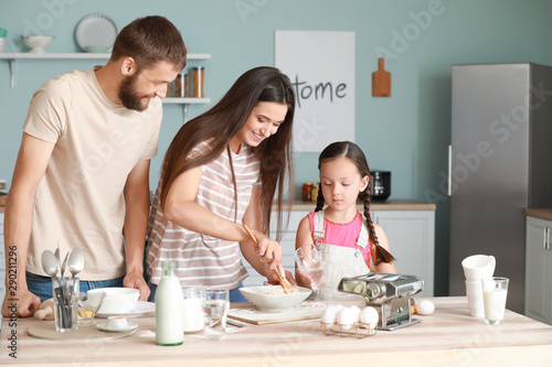 Young family cooking togeth...