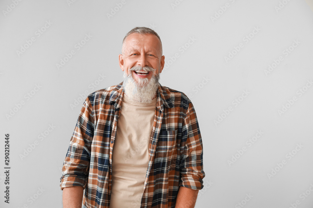 Happy mature man on grey background Happy mature man on grey background