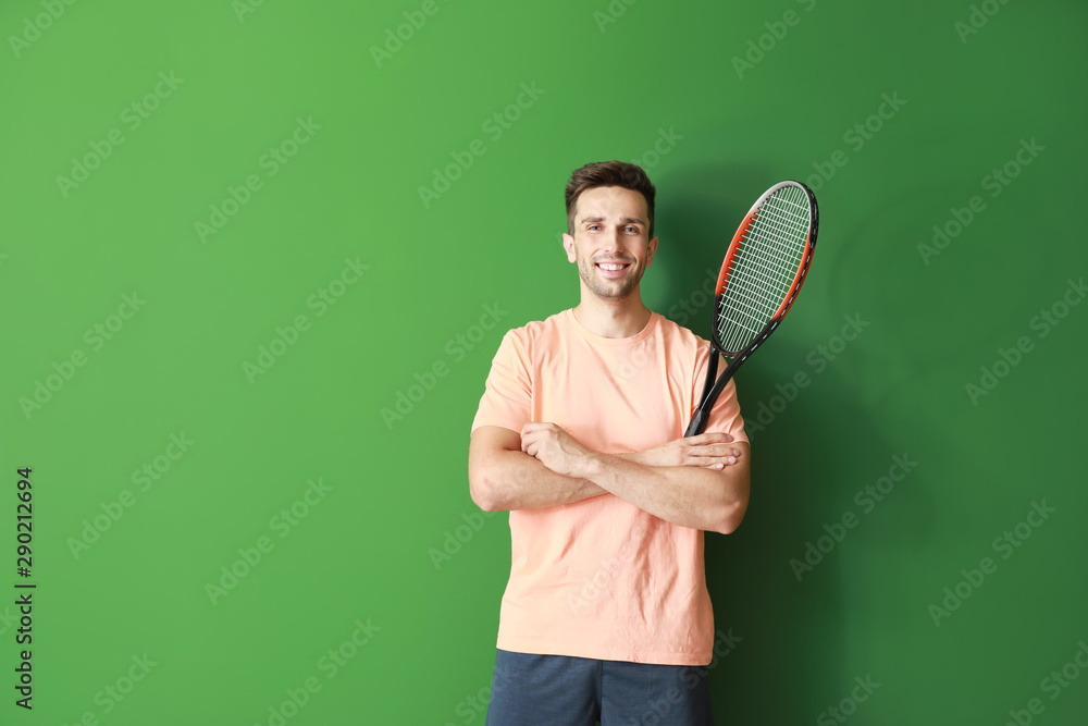 Handsome tennis player on color background
