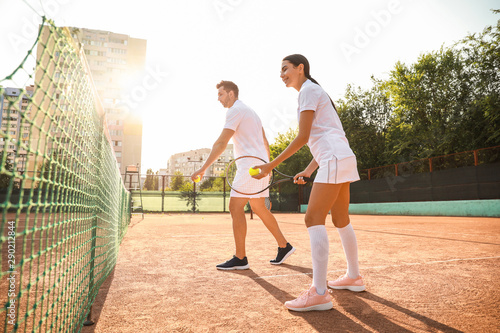 Young couple playing tennis...