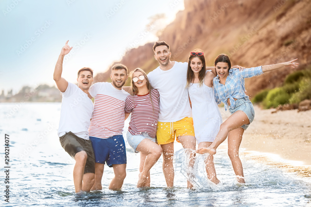 Happy friends on sea beach at resort Happy friends on sea beach at resort