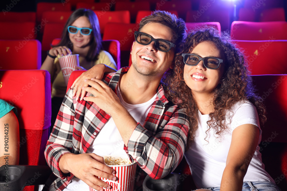 Couple with popcorn watching movie in cinema Couple with popcorn watching movie in cinema