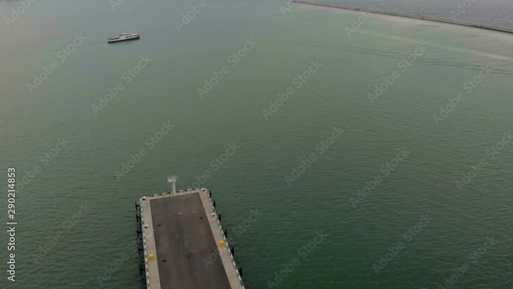 Flight by ship at the pier in the sea. Aerial shot Flight by ship at the pier in the sea. Aerial shot
