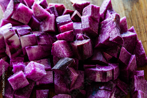 Diced purple yam on a chopping board, close up.