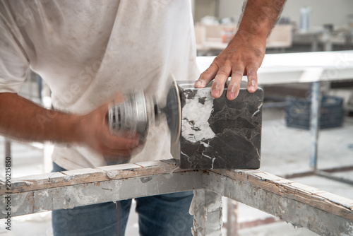 marble craftsman working with power tool