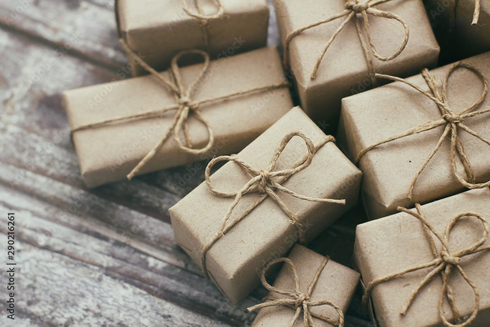 Set of parcel wrapped in craft paper and tie hemp cord. Delivery service. Online shopping. Decorative wooden background. Christmas presents concept. Many gifts. Set of parcel wrapped in craft paper and tie hemp cord. Delivery service. Online shopping. Decorative wooden background. Christmas presents concept. Many gifts.