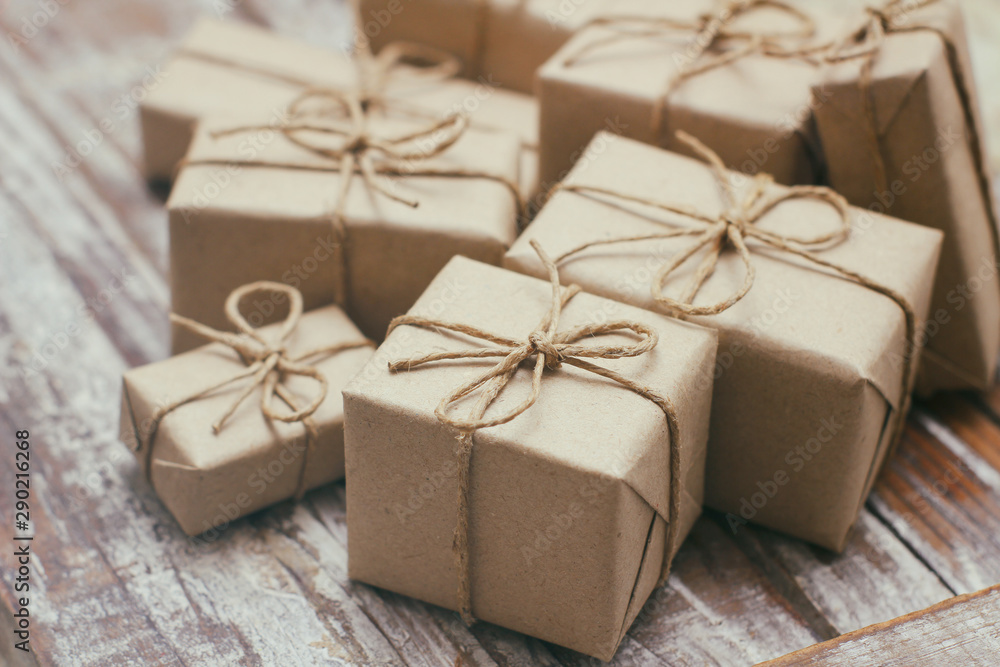 Set of parcel wrapped in craft paper and tie hemp cord. Delivery service. Online shipping. Decorative wooden background. Christmas presents concept. Many gifts. Set of parcel wrapped in craft paper and tie hemp cord. Delivery service. Online shipping. Decorative wooden background. Christmas presents concept. Many gifts.