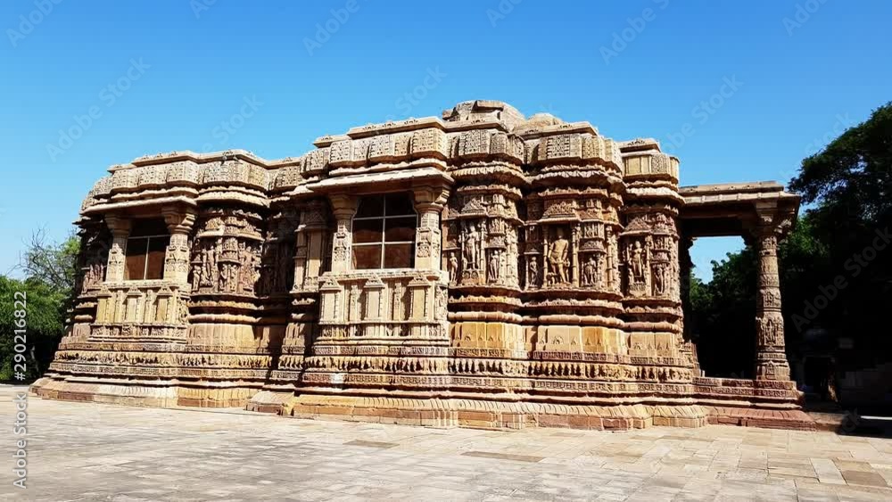 sunlit side view of intricately carved exterior and pillars of the backside of sun temple Modhera which was built in 1026 AD by King Bhimdev of the Solanki dynasty sunlit side view of intricately carved exterior and pillars of the backside of sun temple Modhera which was built in 1026 AD by King Bhimdev of the Solanki dynasty