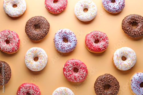 Valokuva Different tasty donuts on color background