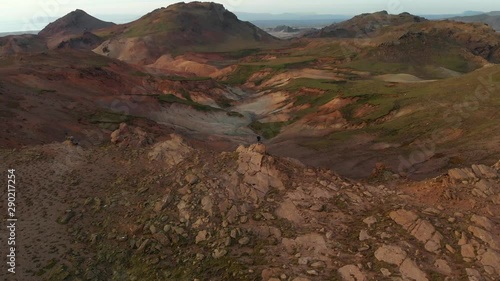 Majestic aerial shot of man sanding in the Icelandic highlands photo