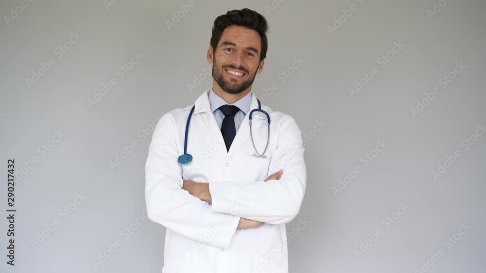 Smiling doctor standing on grey background