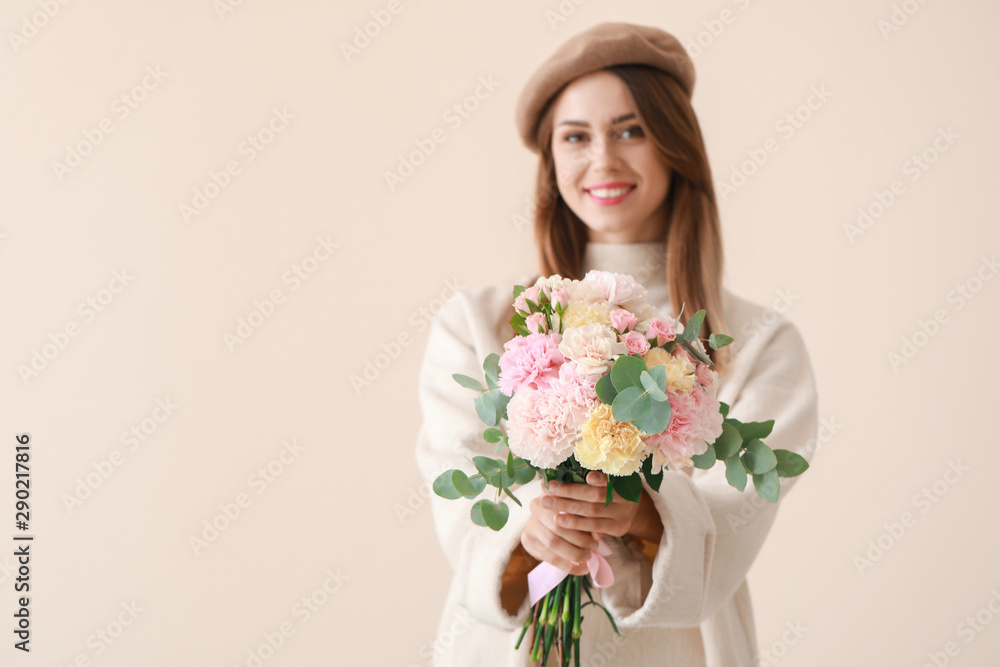 Beautiful young woman with bouquet of carnation flowers on light background Beautiful young woman with bouquet of carnation flowers on light background